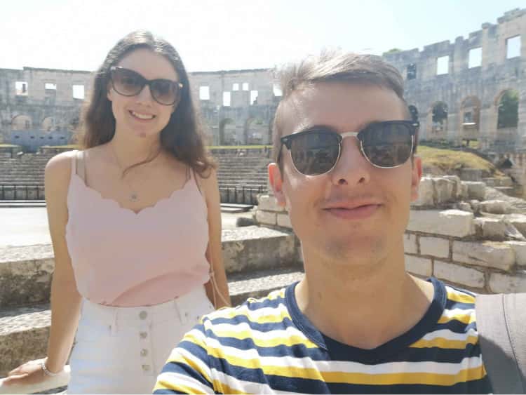 Myself and Naomi, wearing our sunglasses and stood around the side of the colosseum in Pula, Croatia.